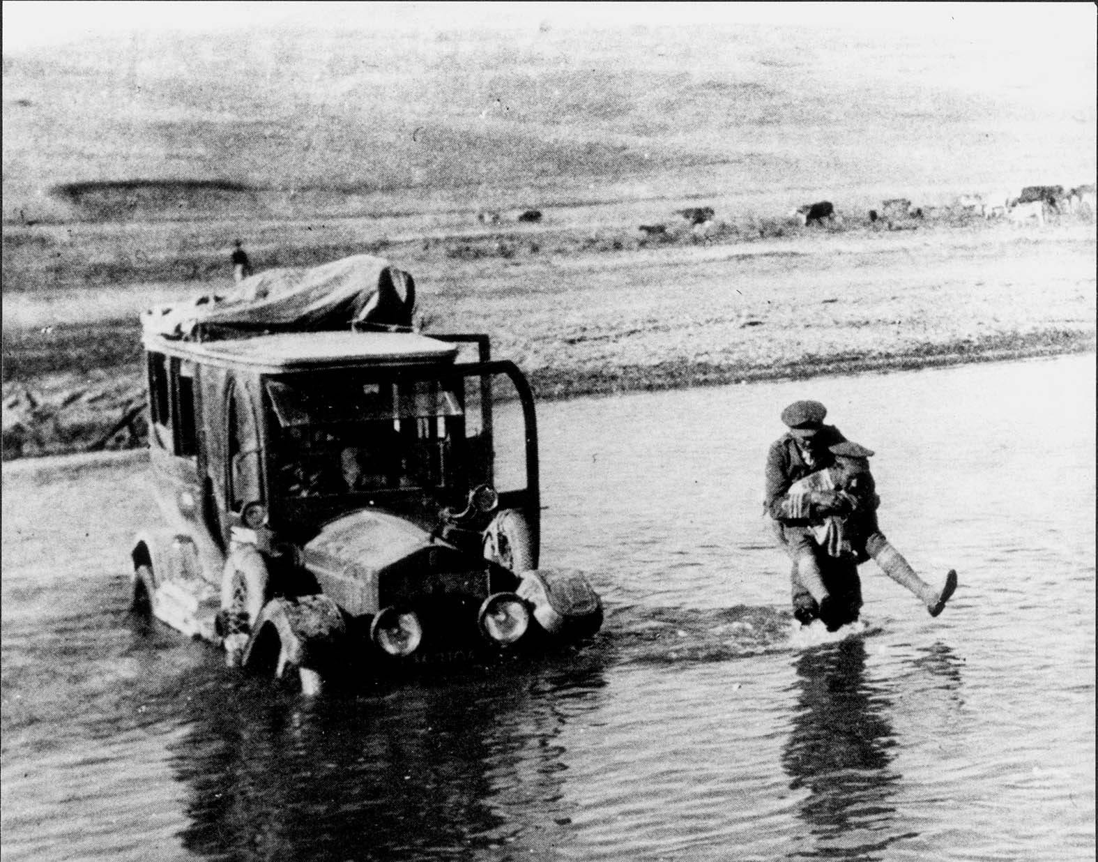 AUB-0025-CDR-Locker-Lampson-being-carried-across-a-river CDR Locker Lampson being carried across a rive