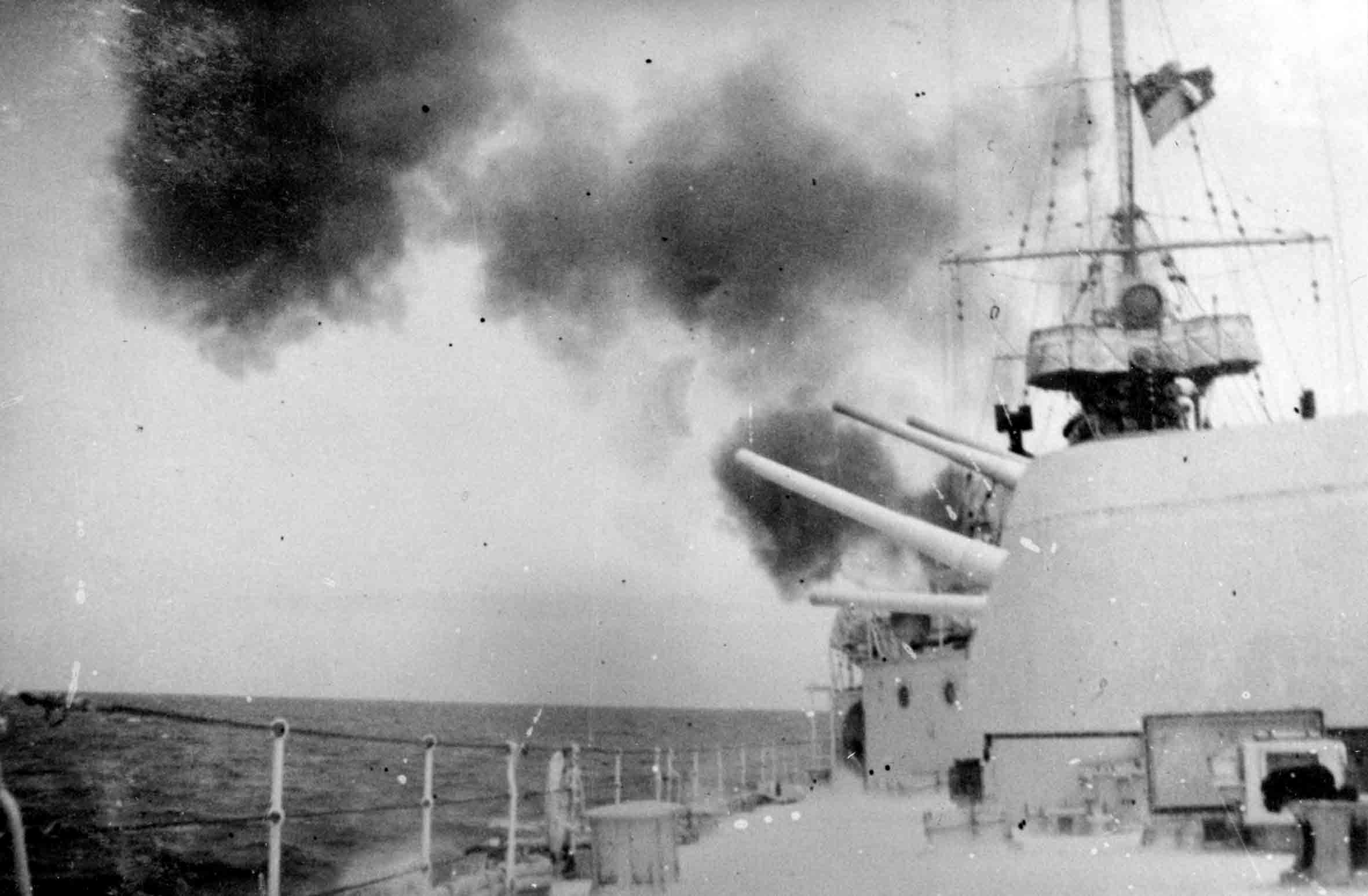 AUG 0195 Achilles X and Y turrets firing HMNZS Achilles X and Y turrets firing at the Battle of the River Plate