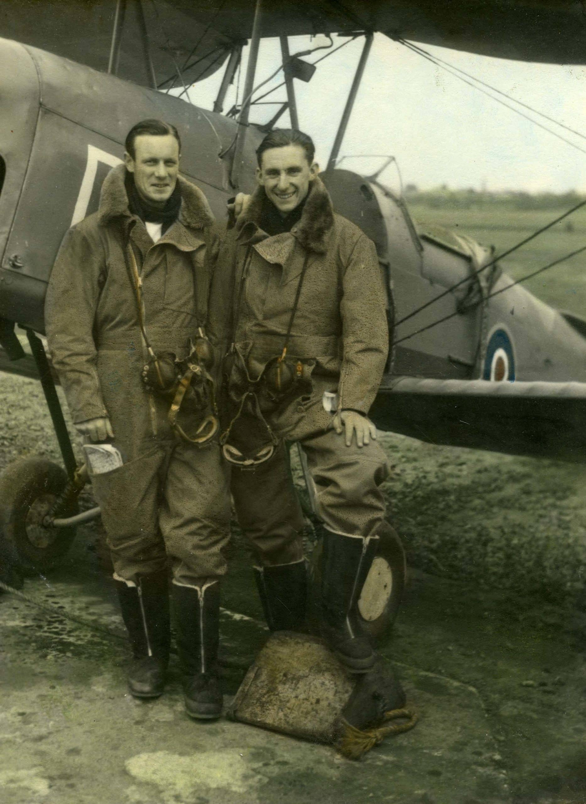 FAA hand coloured FAA Pilots SLT (A) Rod Thompson RNZNVR & SLT (A) J. Pollock RNZNVR in full flying kit beside a Tiger Moth Trainer at RNZAS Elmdon - now Birmingham Airport