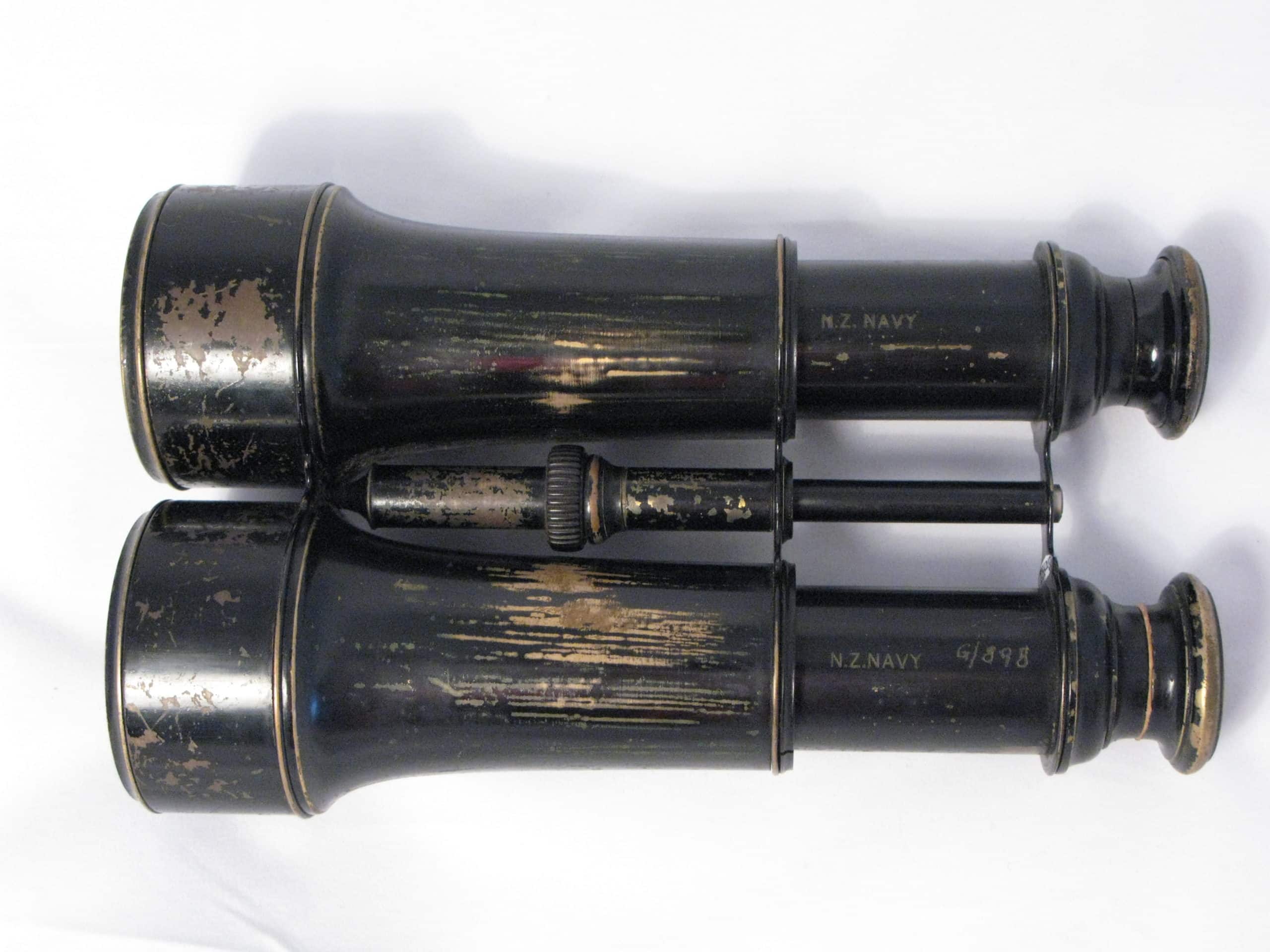 IBB-0003-Binoculars1 Binoculars complete with brown leather case. Glasses have no manufactures mark but each barrel is marked: ‘NZ Navy’. Case was made by George Bussey & Co. Ltd 1917.