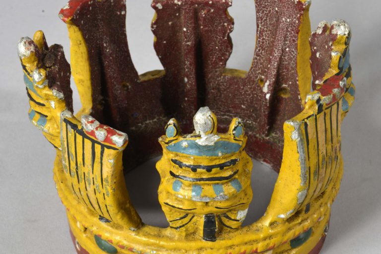 crown1 Metal painted crown attached to short section of wooden masthead. Masthead crown is believed to have been from HMS New Zealand.
