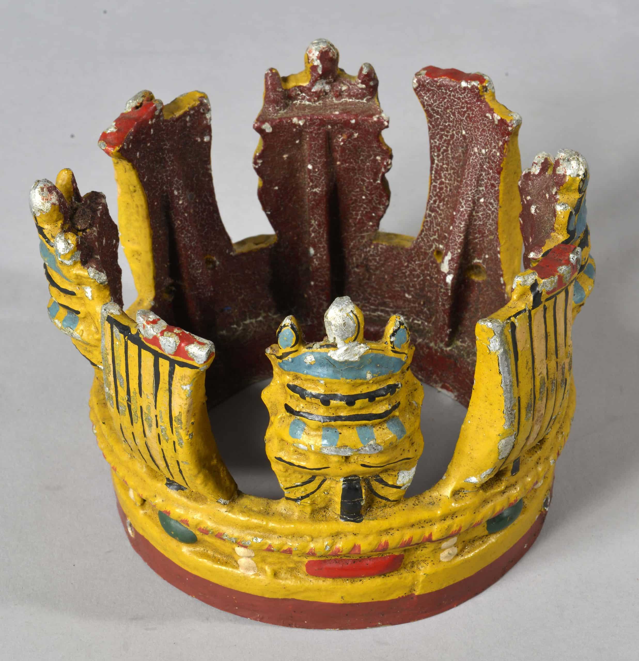 crown1 Metal painted crown attached to short section of wooden masthead. Masthead crown is believed to have been from HMS New Zealand.