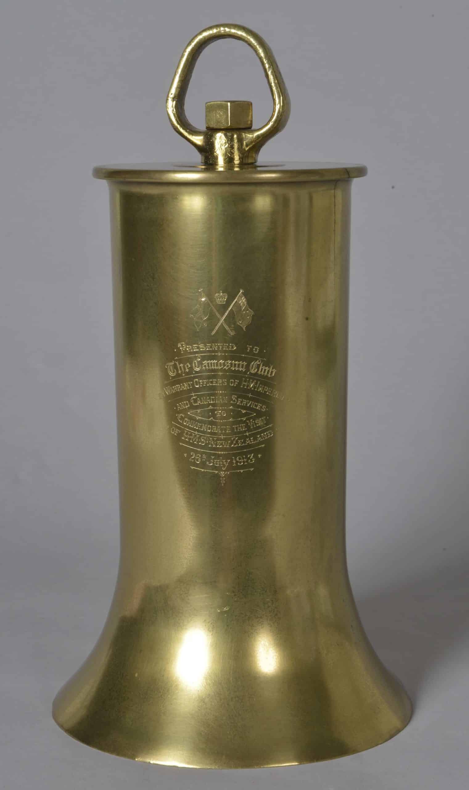 presentation-bell1 Brass presentation bell with clapper. Bell given to the Camosun Club of Victoria, British Colombia, by the Warrant Officers of HMS New Zealand. Inscribed on the bell are the words: ‘Presented to The Camosun Club by Warrant Officers of HM Imperial and Canadian Services to Commemorate the Visit of HMS New Zealand 26th July 1913’.